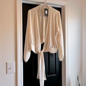 White blouse from Fashion Nova. Brand new with tags. Low cut. Tie front.